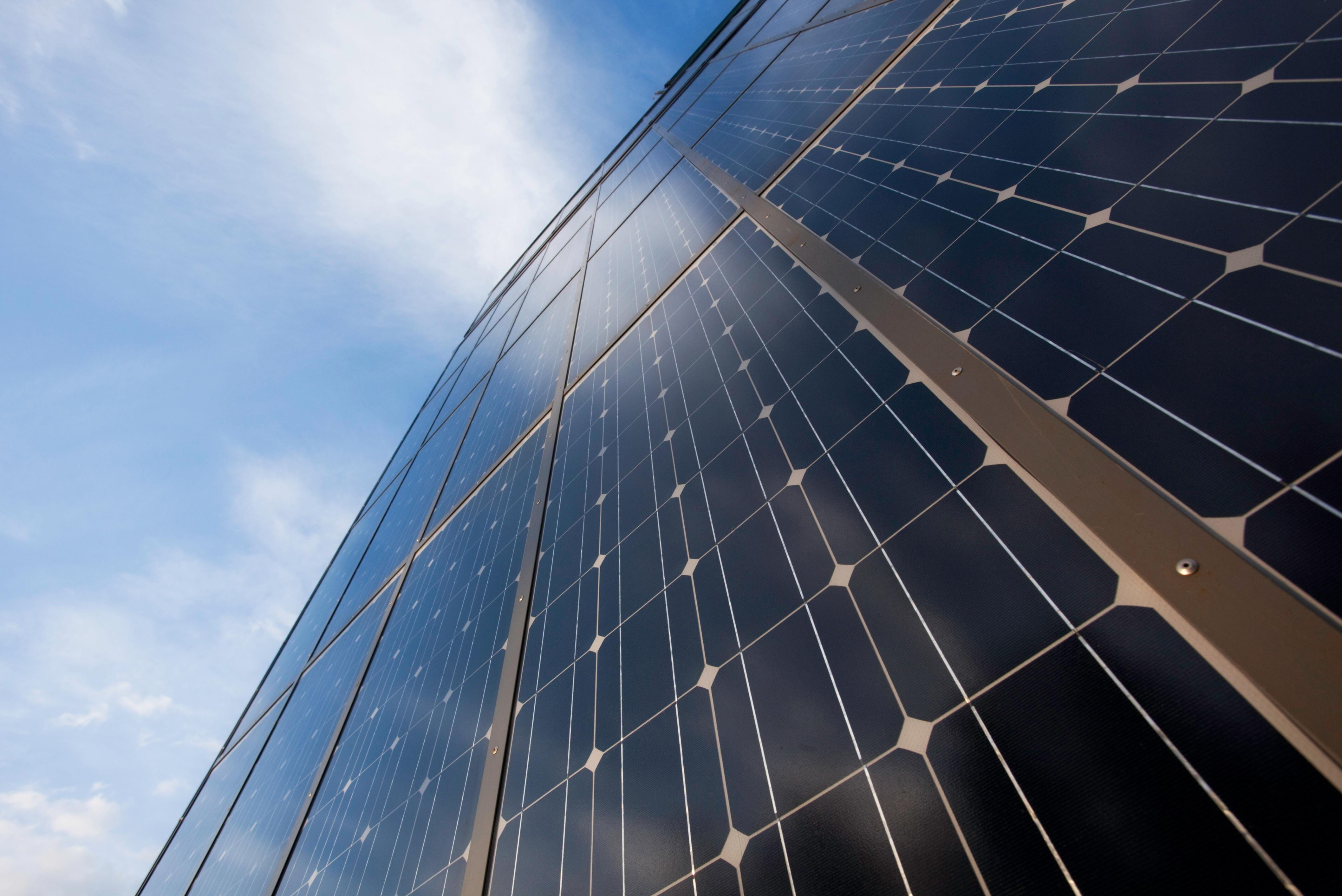 Grid-tie solar panels under a blue sky